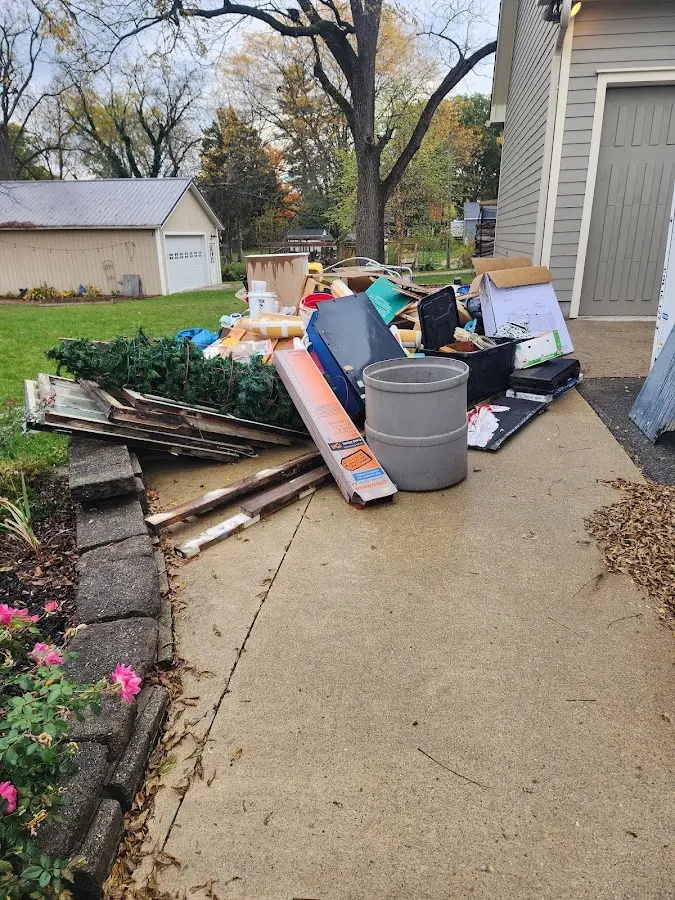 Dumpster being loaded with debris for Estate Cleanout Dumpster Rental in San Fernando
